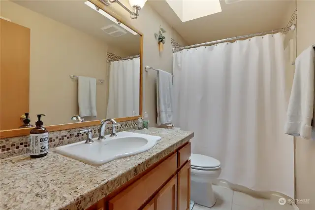 Primary En Suite Upgrade Bath w/Tile Flooring & Shower Surround, Granite Counter, Newer Sink and Skylight!