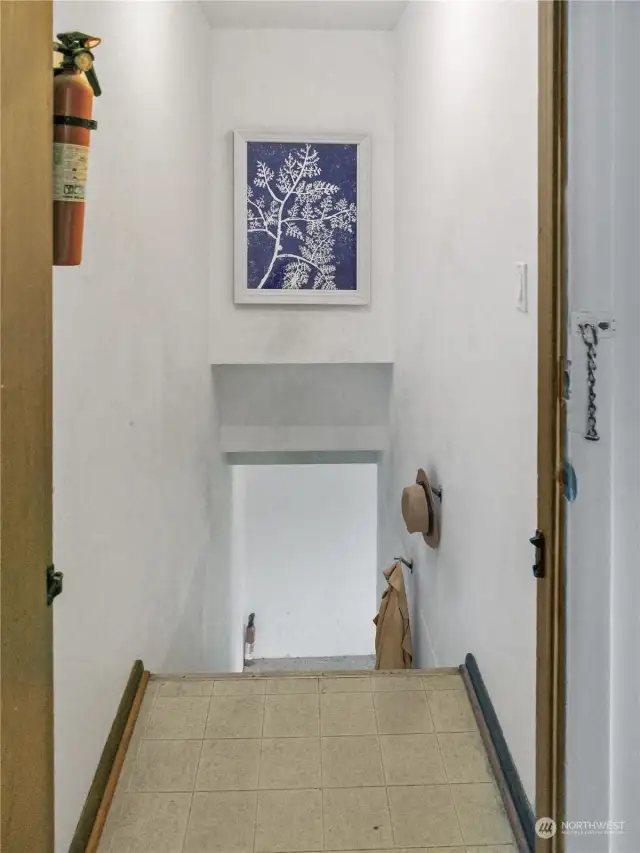 View of stairs to the fully finished basement (virtually staged).