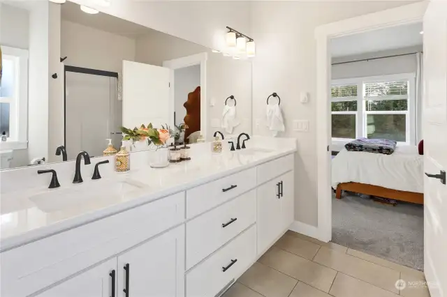 Twin sinks accommodate the morning rush and note the large shower in the mirror.