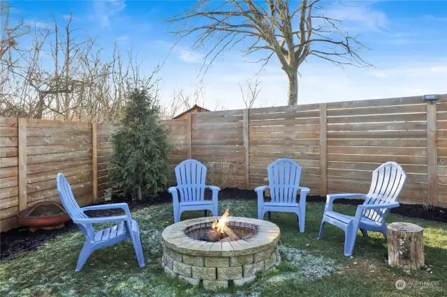 This firepit transforms the yard into a cozy, inviting retreat, perfect for year-round enjoyment.