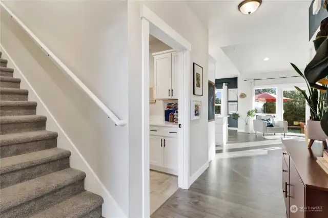 The foyer directs traffic to all areas of the home.   To the left, the stairs to the upper level family room and next to that, the utility room and garage access.  Straight ahead, the Gathering Room awaits.