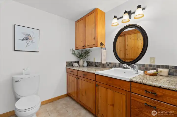 Half bath and storage around the corner from the kitchen.