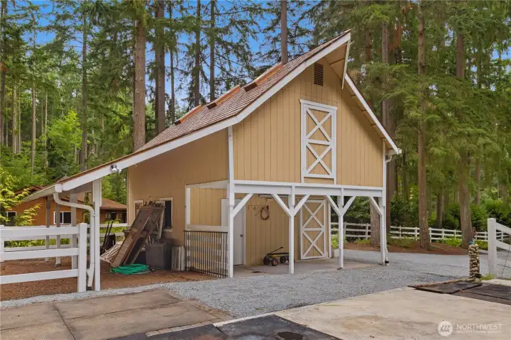 Well built barn with a metal roof and skylights.