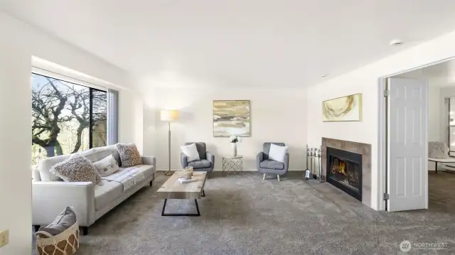 The living room offers the perfect ambiance with the natural light and the cozy fireplace.