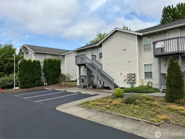 Front of building with parking lot and new blacktop