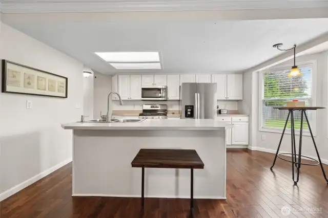 Kitchen has both eat in bar and separate space for an eating nook
