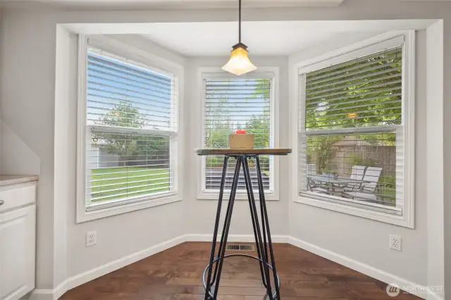 Off the kitchen this eating nook has lots of windows for view of backyard and tons of natural lighting