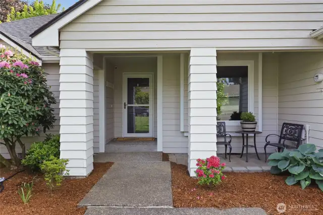 Walking to the front entrance with a covered patio