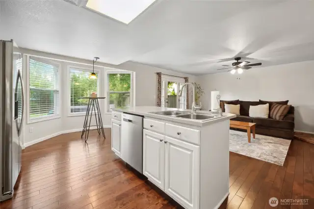 Walking into the kitchen with a center island that opens up to the great room