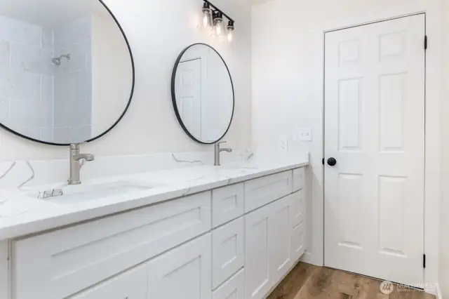 Full bath located on 2nd level. New vanity and mirrors brightens this space.