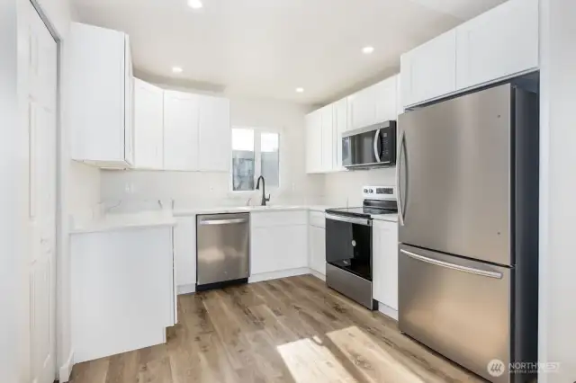 Light and bright kitchen with new cabinets and countertops.