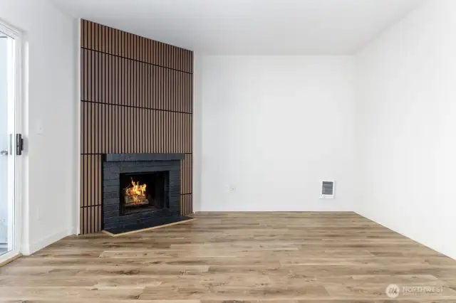 Wood slabs modernize the wood burning fireplace.