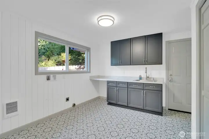 Laundry room includes a closet door with built in ironing boards