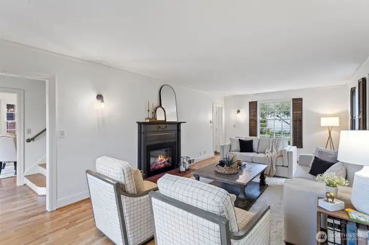 The spacious living room offers space for large scale furniture centered around a cozy fireplace.