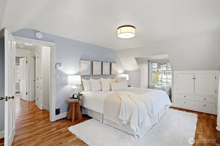 The primary bedroom has a peek-a-boo view of the sound, the perfect reading nook.