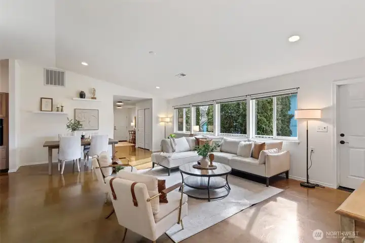 Enormous great room with vaulted ceilings and gorgeous polished concrete floors.