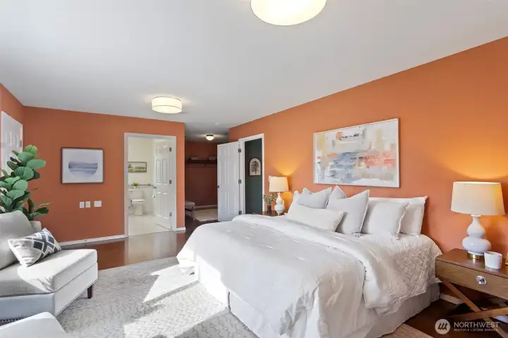 Primary bedroom with view of walk in closet and ensuite 3/4 bathroom.