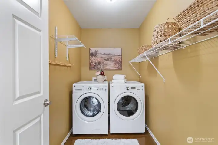 Spacious laundry room with hanging racks and storage.