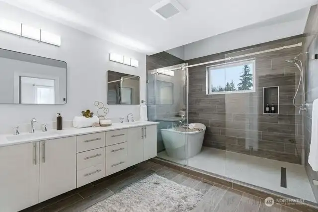 Gorgeous Primary bathroom with soaking tub and heated floors & tile wrapped walls