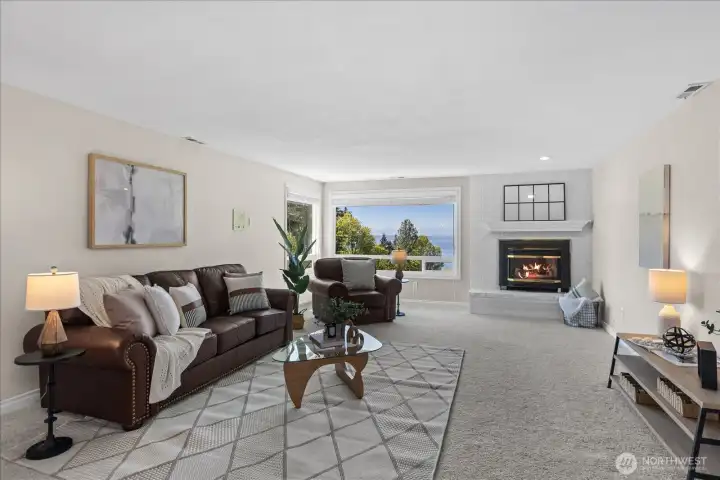 Upstairs living area mimics the main floor with large picture windows to take in the views and a gas fireplace those cold PNW nights.