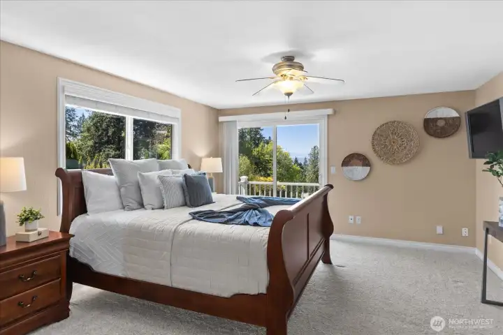 Wake up to magnificent views and fresh air from this primary suite, which includes private access to a secluded balcony through large sliding glass doors.