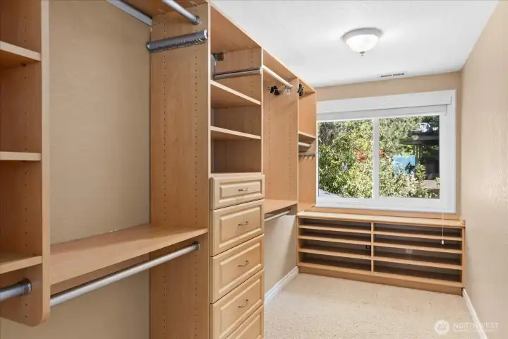 The oversized primary suite closet is a storage dream, complete with custom cabinetry.