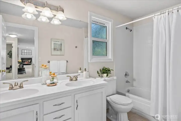 Upstairs full bath with double vanity.