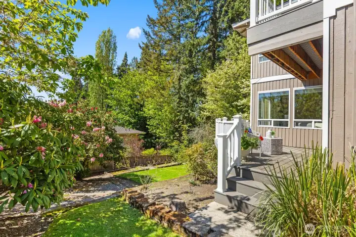 Beautifully maintained lawn/garden area with diverse mature landscaping.