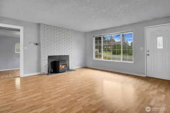 Huge living room with cozy fireplace insert.