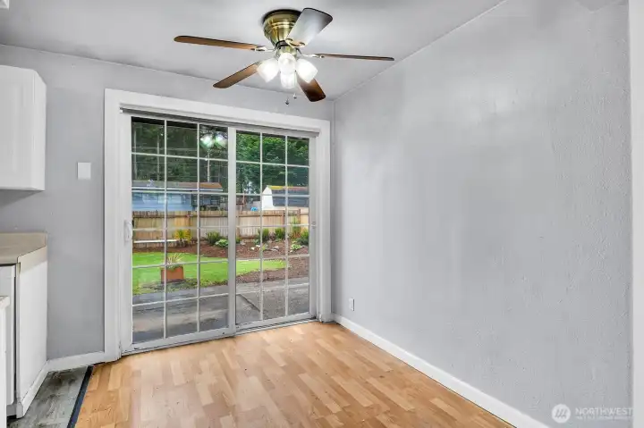 Dining area with access to the patio and large yard. Interior paint needed; some photos are better than actual.