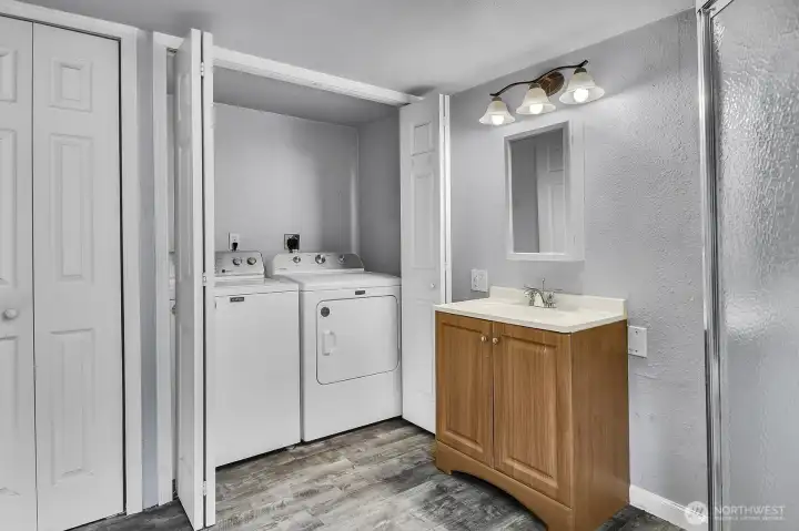 Convenient laundry in the Primary Bath as well as another closet for storage.