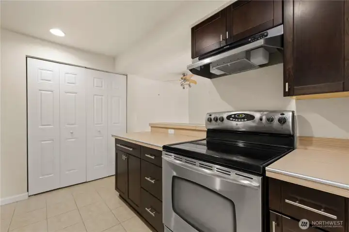 Stainless steel range and hood. Laundry is in the closet to the left.