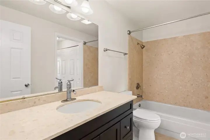Bathroom has an ensuite door to the main bedroom and additional door off the hallway.