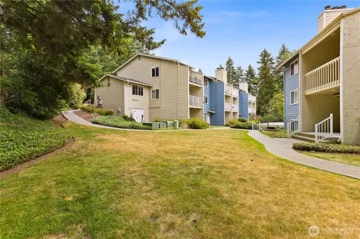 There are grass areas between the buildings.