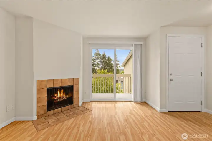 Wood burning fireplace and slider door to the private balcony.