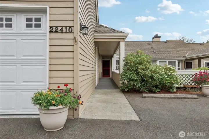 Covered walkway to front door from garage side door.