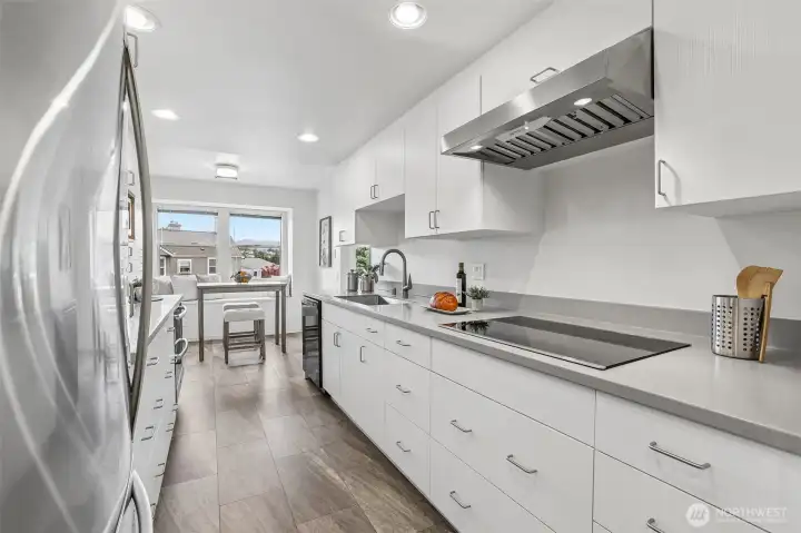 Convection cooktop, stainless steel appliances, pull out drawers and workspaces.