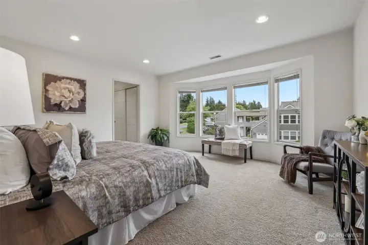 Primary bedroom with space for larger furniture, side tables and bureau.