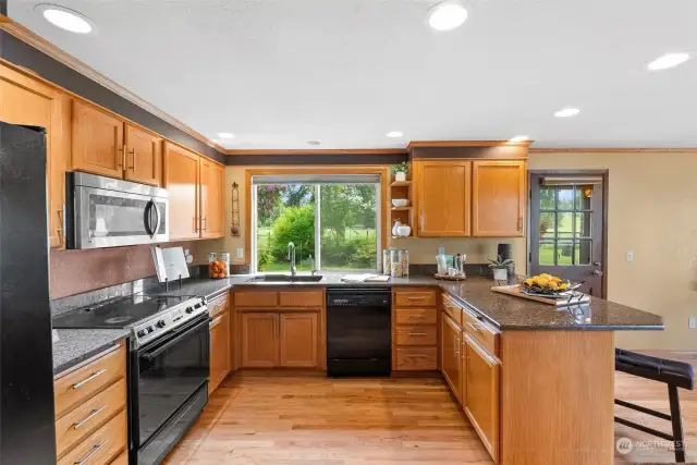 This kitchen is a chef's delight with so much countertop space. Granite countertops.
