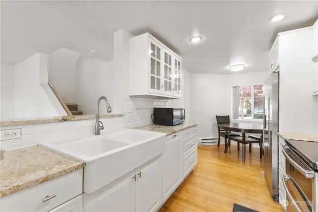 ANOTHER VIEW OF THIS WONDER LARGE KITCHEN LOADED WITH UPDATES INCLUDING NEWER APPLIANCES THAT STAY WITH HOME.  THERE IS GOOD SIZE EAT IN KITCHEN AREA WITH BAR LOOKING AT TO VIEW WHILE YOU ENJOY ENTERTAINING