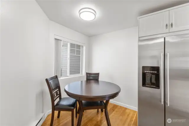 HERE IS GOOD SIZED EAT IN KITCHEN WITH MODERN LIGHTING HARD WOOD FLOORING AND WINDOW TO LET EVEN MORE LIGHT IN.  THIS IS MUST SEE AT THIS PRICE