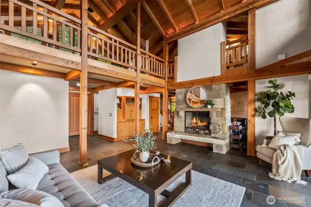 Another view of the GREAT room.  Lots of space.  Loft above to the right.  Office/art studio with tree trunk to the right.   Cozy reading/relax space behind fireplace.  All flooring in in-floor radiant heating and is slate tile.