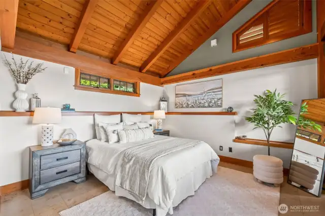 Primary bedroom on main floor.  Car-decking vaulted ceilings are so charming.