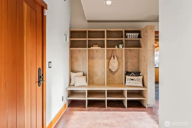 On the main level, the door on the left opens out to the front.  This is the mud/utility area and has lots of storage and useage. The flooring in this area and out to the garage is concrete.