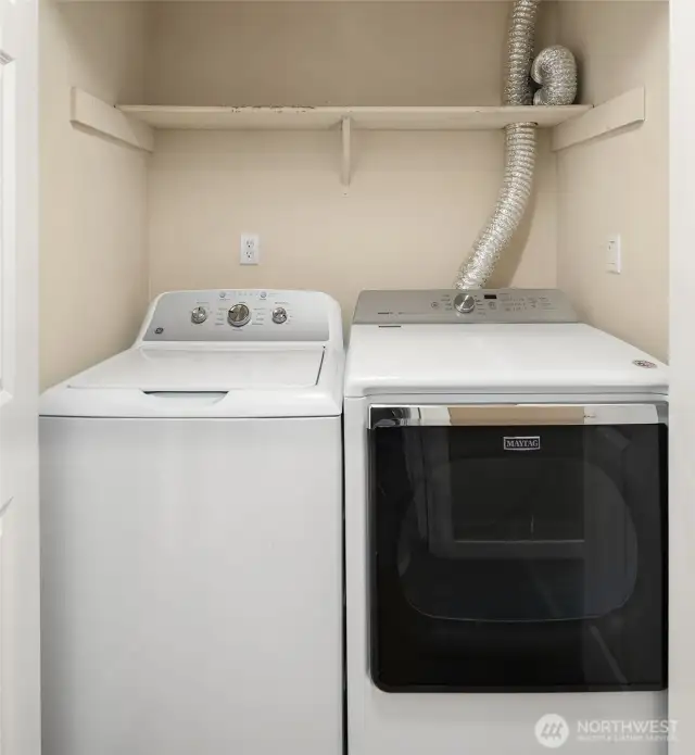 In-unit washer dryer in hallway to the right of front door