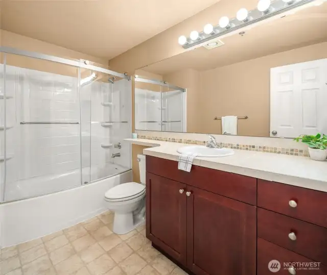 Bathroom at the end of hallway by laundry