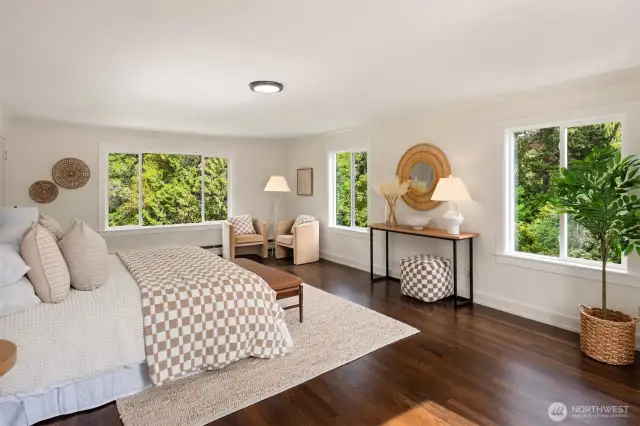 Serene and sunlit—primary bedroom, upper level.