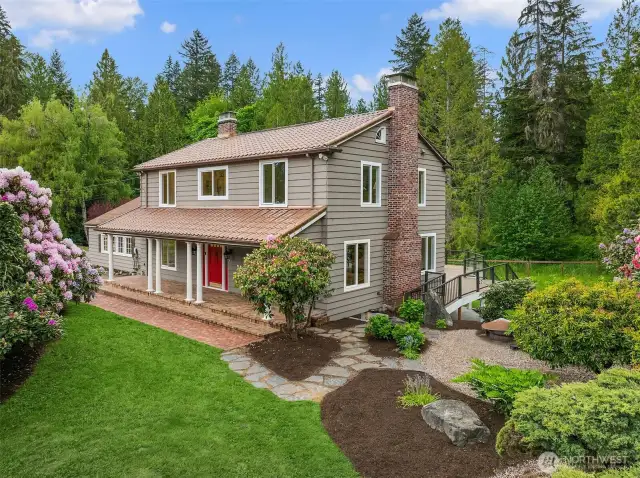 Charming Euro-inspired architecture tucked above a lush backyard and creekside sanctuary.