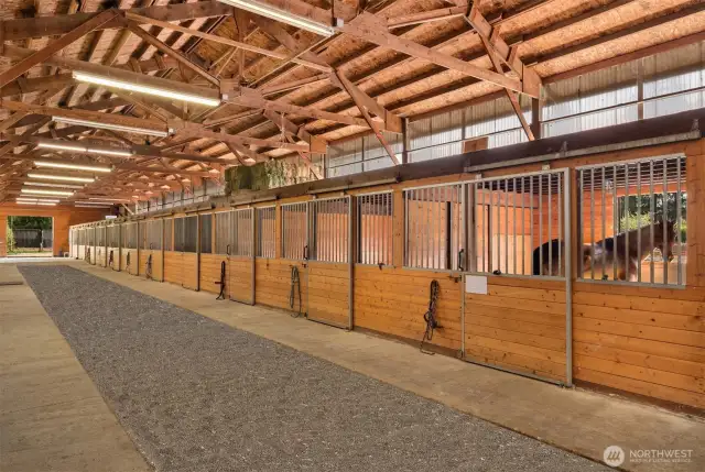 Light and bright, 11-stall barn with excellent airflow, attached runs, and two spacious tack rooms. Multiple interior barn upgrades 2023.