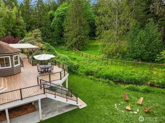 Expansive deck and patio set the stage for backyard escapes, outdoor fun and creekside relaxation.